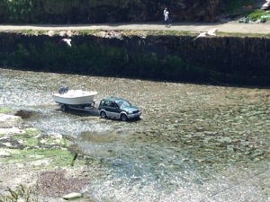 An interesting study. Why would one drive down a river towing a boat?